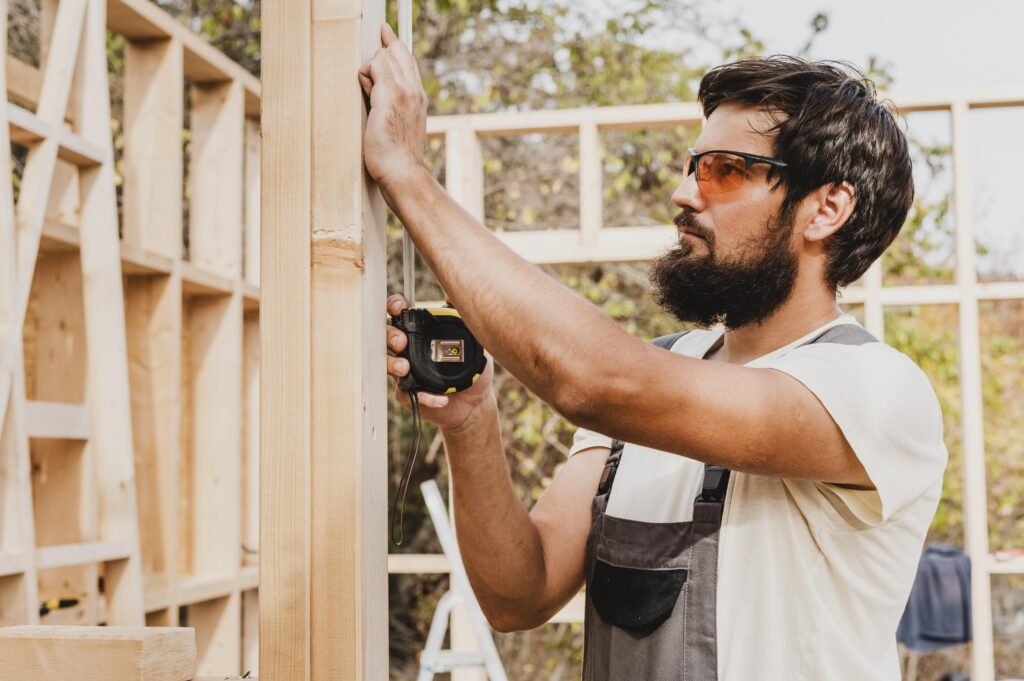 carpenter man using tape measure